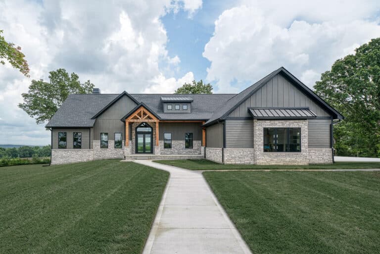A gray modern-farmhouse home clad in LP SmartSide board-and-batten and lap siding with stone accents and a timber-truss entry